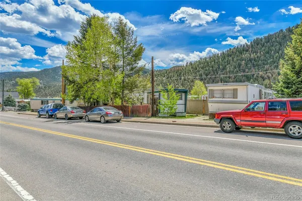 a view of a cars parked on the side of a street