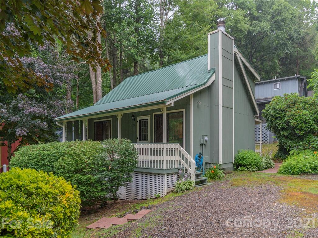 79 Susan Drive Maggie Valley, NC 28751 - Photo 1 of 17 a front view of a house with garden