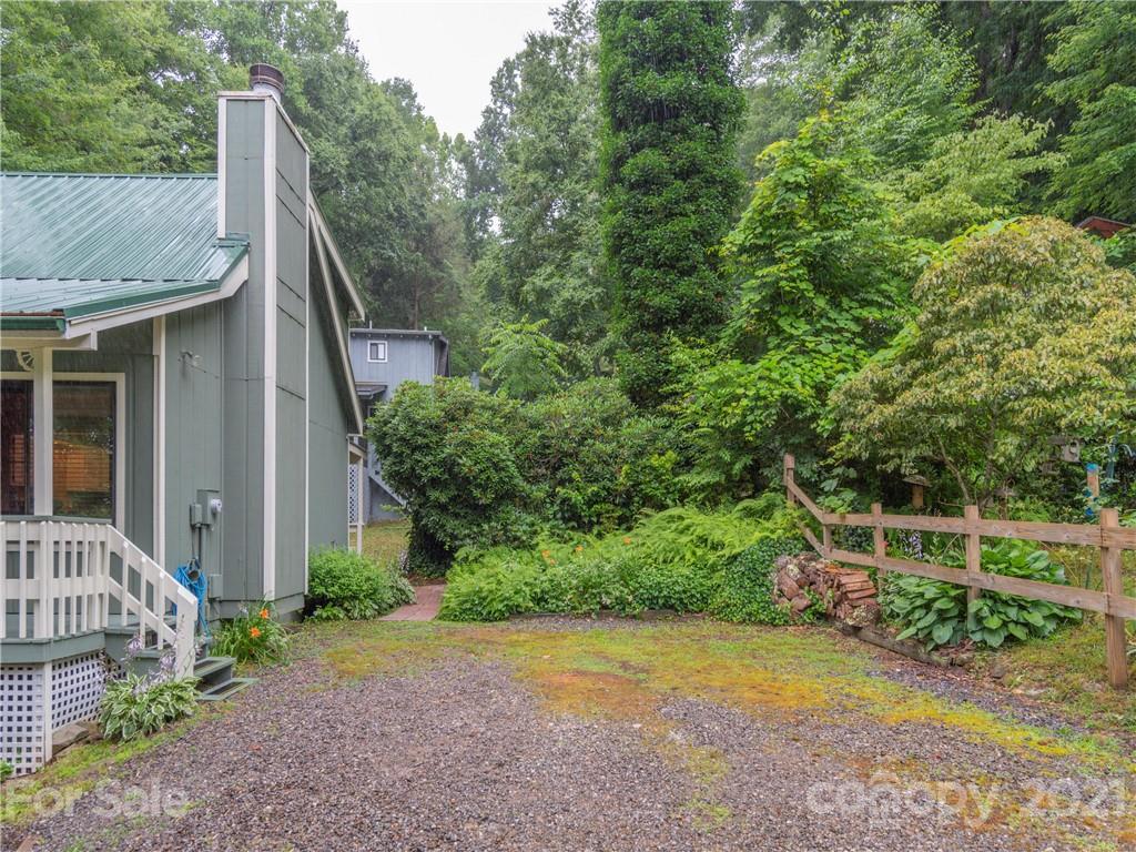 79 Susan Drive Maggie Valley, NC 28751 - Photo 17 of 17 a view of a backyard with plants and large trees