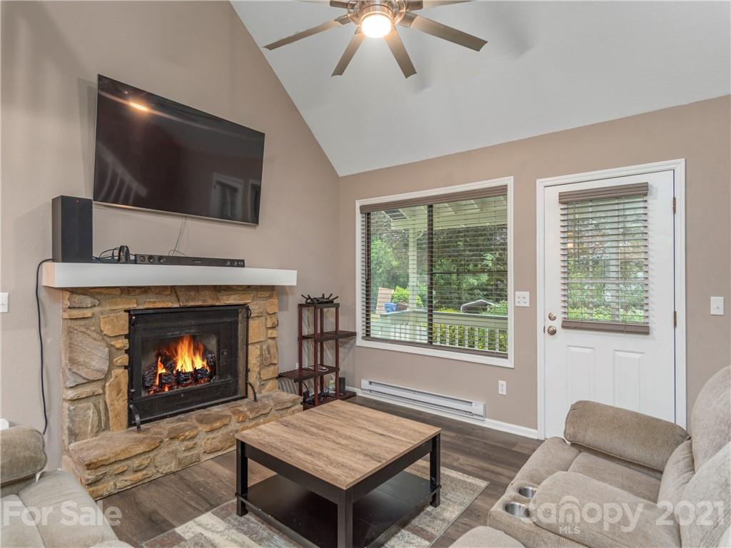 79 Susan Drive Maggie Valley, NC 28751 - Photo 3 of 17 a living room with furniture a flat screen tv and a fireplace
