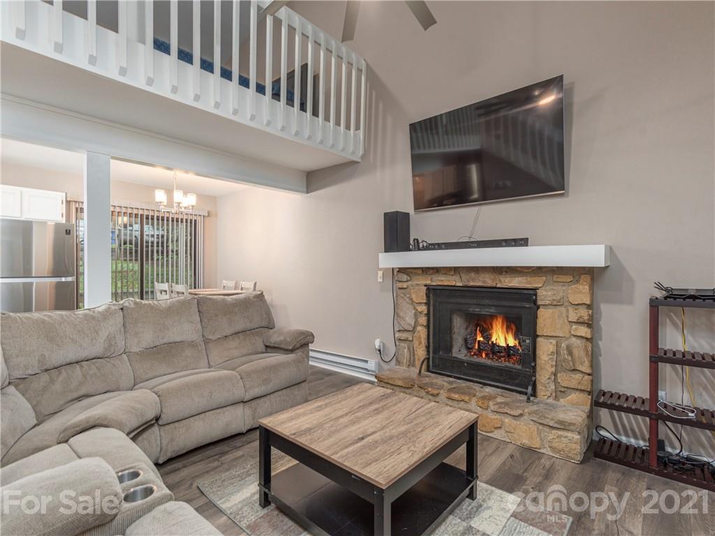 79 Susan Drive Maggie Valley, NC 28751 - Photo 4 of 17 a living room with furniture a flat screen tv and a fireplace