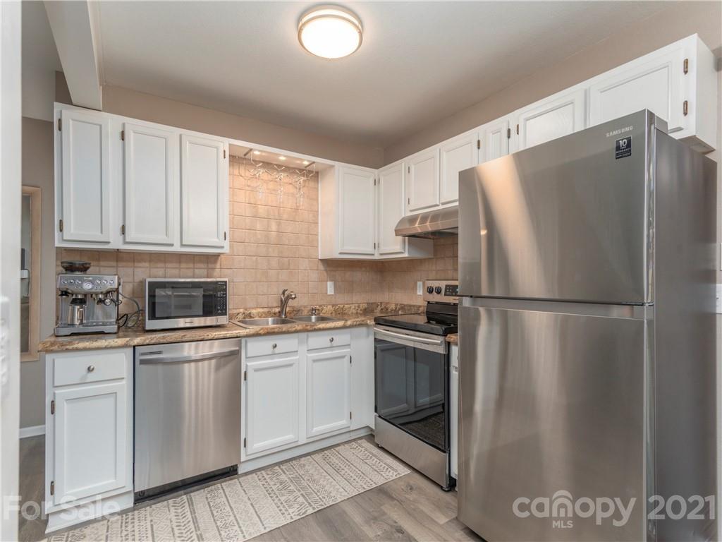 79 Susan Drive Maggie Valley, NC 28751 - Photo 7 of 17 a kitchen with stainless steel appliances granite countertop a refrigerator sink and stove