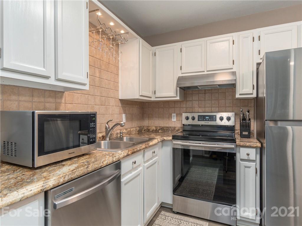 79 Susan Drive Maggie Valley, NC 28751 - Photo 8 of 17 a kitchen with granite countertop a stove sink and refrigerator