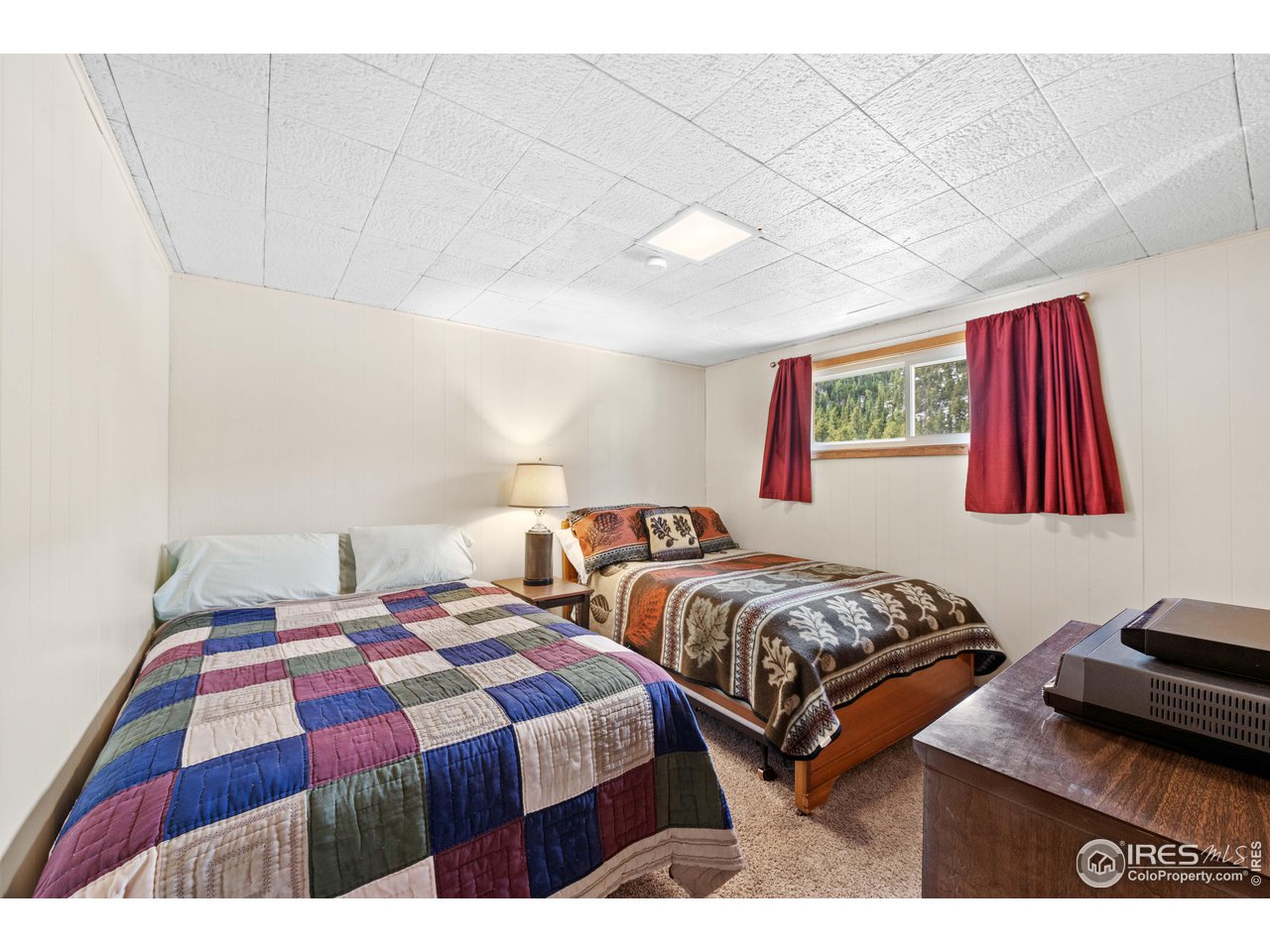 654 Hemlock Drive Lyons, CO 80540 - Photo 13 of 32 a bedroom with two beds and a dresser