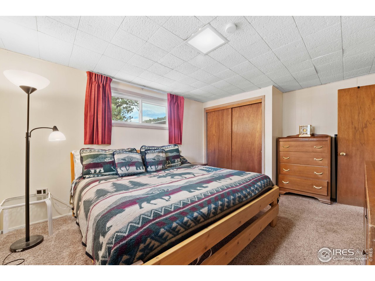 654 Hemlock Drive Lyons, CO 80540 - Photo 15 of 32 a bedroom with a bed and dresser