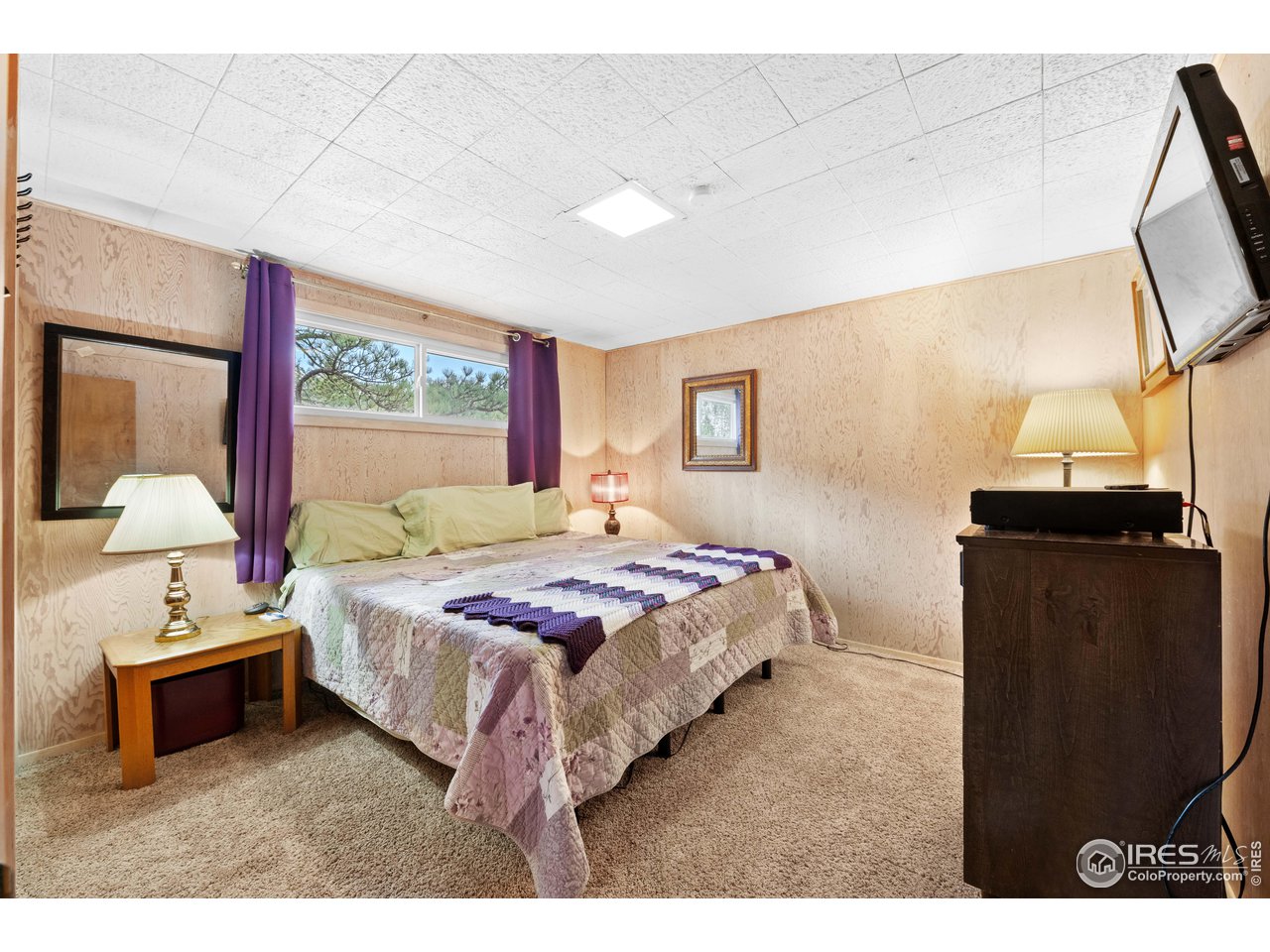 654 Hemlock Drive Lyons, CO 80540 - Photo 17 of 32 a bedroom with a bed and a mirror