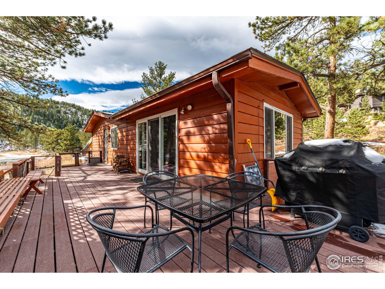 654 Hemlock Drive Lyons, CO 80540 - Photo 3 of 32 a backyard of a house with barbeque oven table and chairs