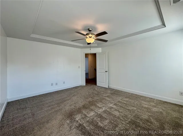 an empty room with a ceiling fan and a window