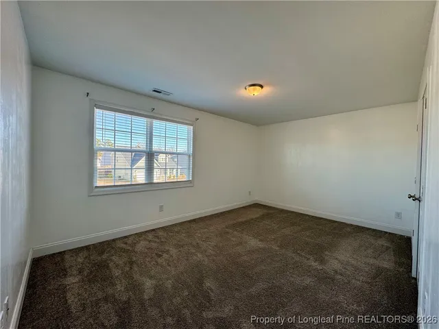 an empty room with a empty space and windows