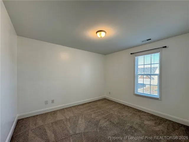 an empty room with a empty space and windows