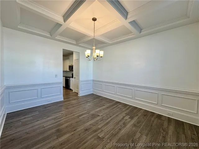 a view of a livingroom with wooden floor and a ceiling fan