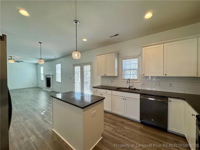 a kitchen with stainless steel appliances granite countertop a sink a stove and a granite counter tops