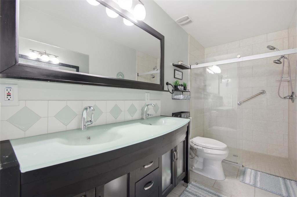 13 Slowdrift Palm Coast, FL 32164 - Photo 18 of 58 a bathroom with a sink a toilet and a mirror
