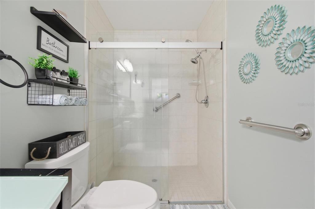 13 Slowdrift Palm Coast, FL 32164 - Photo 19 of 58 a bathroom with a toilet and a shower