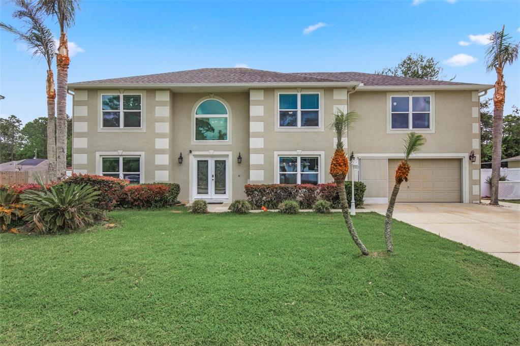 13 Slowdrift Palm Coast, FL 32164 - Photo 2 of 58 a front view of a house with a yard
