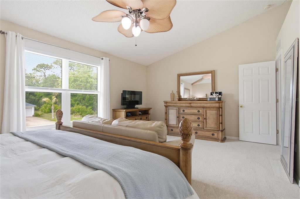 13 Slowdrift Palm Coast, FL 32164 - Photo 25 of 58 a bedroom with a bed and a flat screen tv