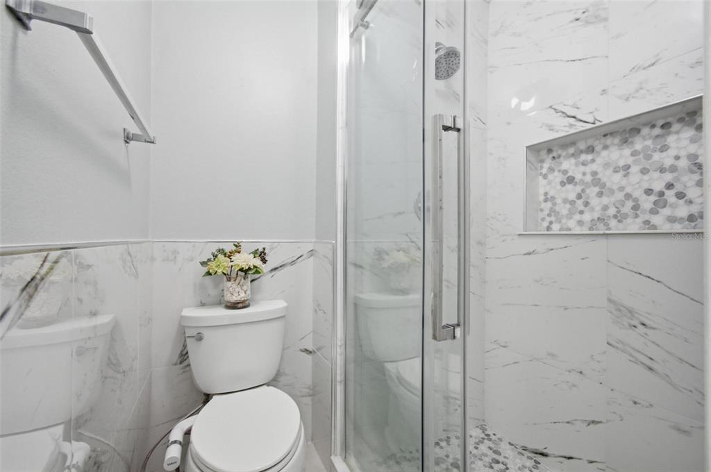13 Slowdrift Palm Coast, FL 32164 - Photo 28 of 58 a white toilet sitting next to a bathroom sink
