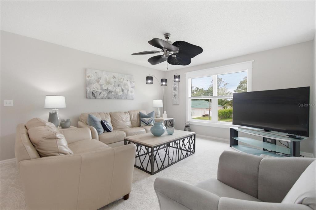 13 Slowdrift Palm Coast, FL 32164 - Photo 30 of 58 a living room with furniture and a flat screen tv