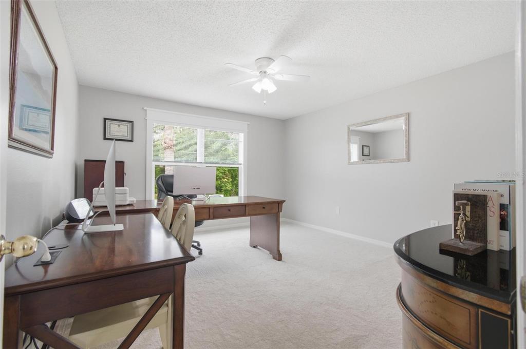 13 Slowdrift Palm Coast, FL 32164 - Photo 37 of 58 a view of a workspace with furniture and a window