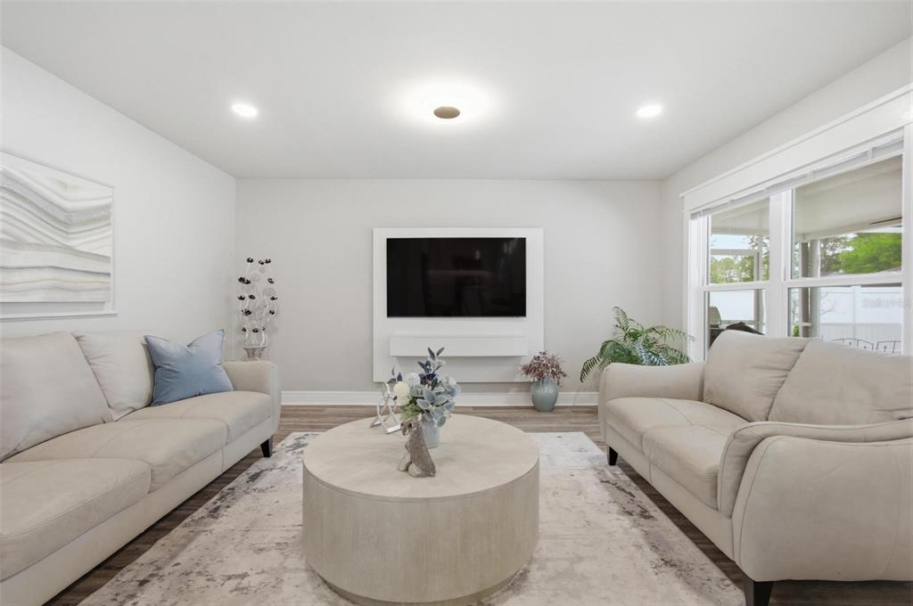 13 Slowdrift Palm Coast, FL 32164 - Photo 8 of 58 a living room with furniture and a flat screen tv