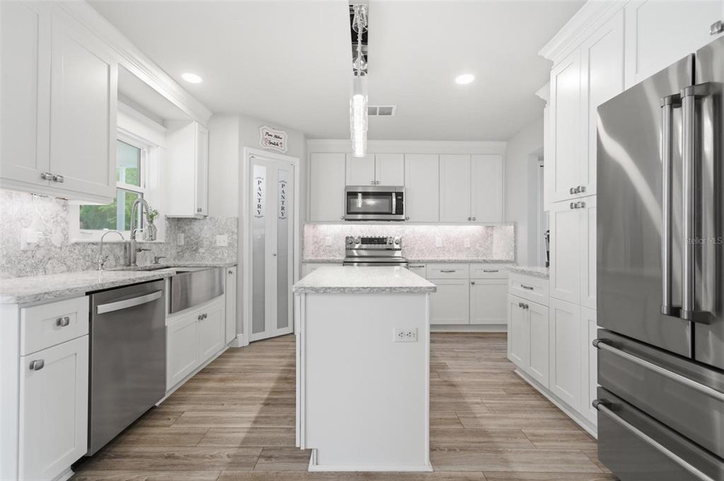13 Slowdrift Palm Coast, FL 32164 - Photo 10 of 58 a kitchen with white cabinets and stainless steel appliances