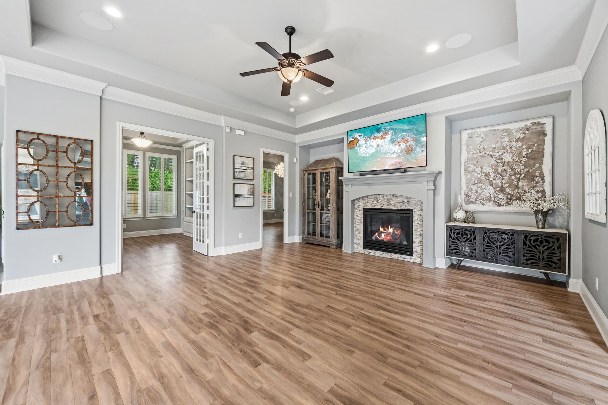 19908 Cullen Ridge Drive Porter, TX 77365 - Photo 7 of 42 Open living room with gas fireplace and beautiful trey ceiling, crown moulding, study off living room with French doors.