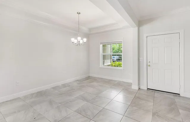 an empty room with windows and entrance