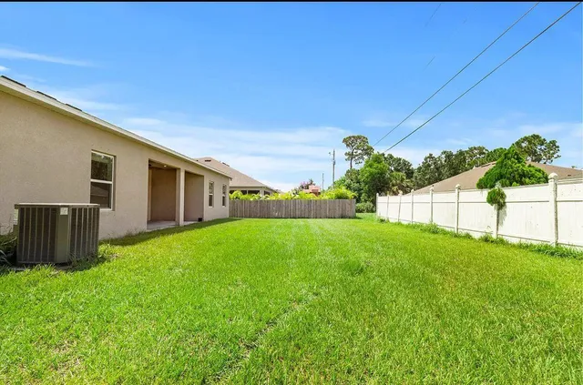 a view of a backyard with plants and a garden