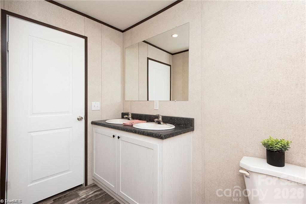 1975 Carl Fox Road Taylorsville, NC 28681 - Photo 23 of 33 a bathroom with a granite countertop sink and a mirror