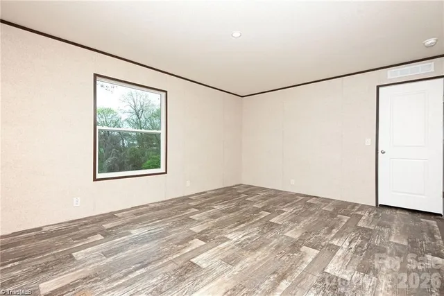 a view of a big room with an empty space and a window