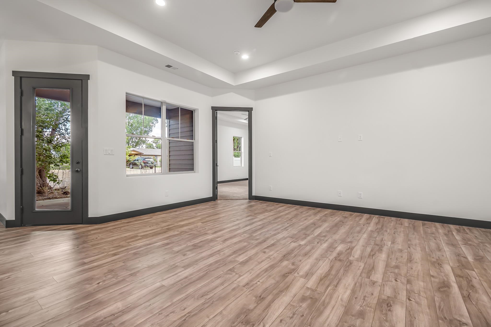 796 Spur Cross Road Grand Junction, CO 81505 - Photo 6 of 24 wooden floor in an empty room with a window