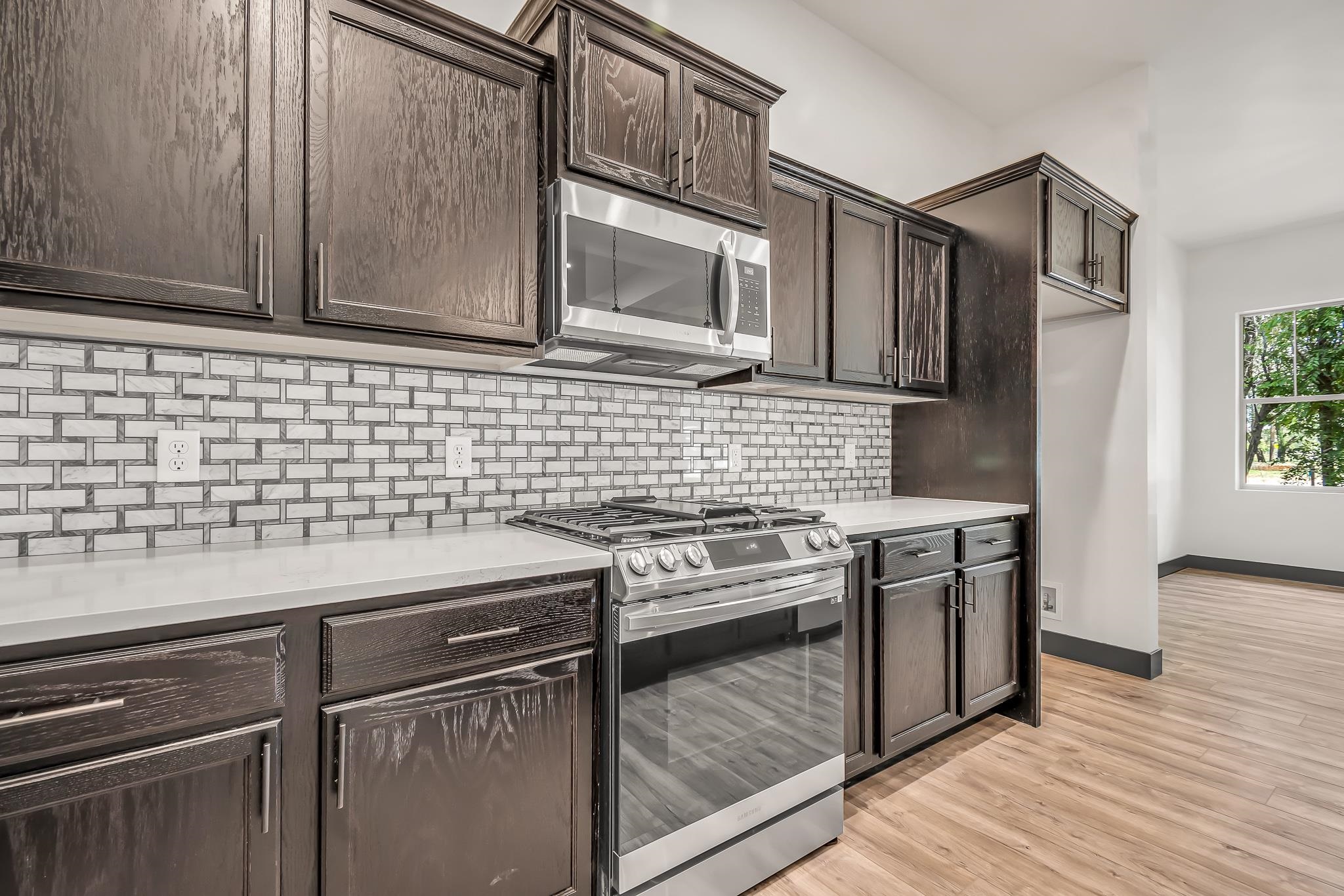 796 Spur Cross Road Grand Junction, CO 81505 - Photo 8 of 24 a kitchen with stainless steel appliances granite countertop a stove a sink and a microwave
