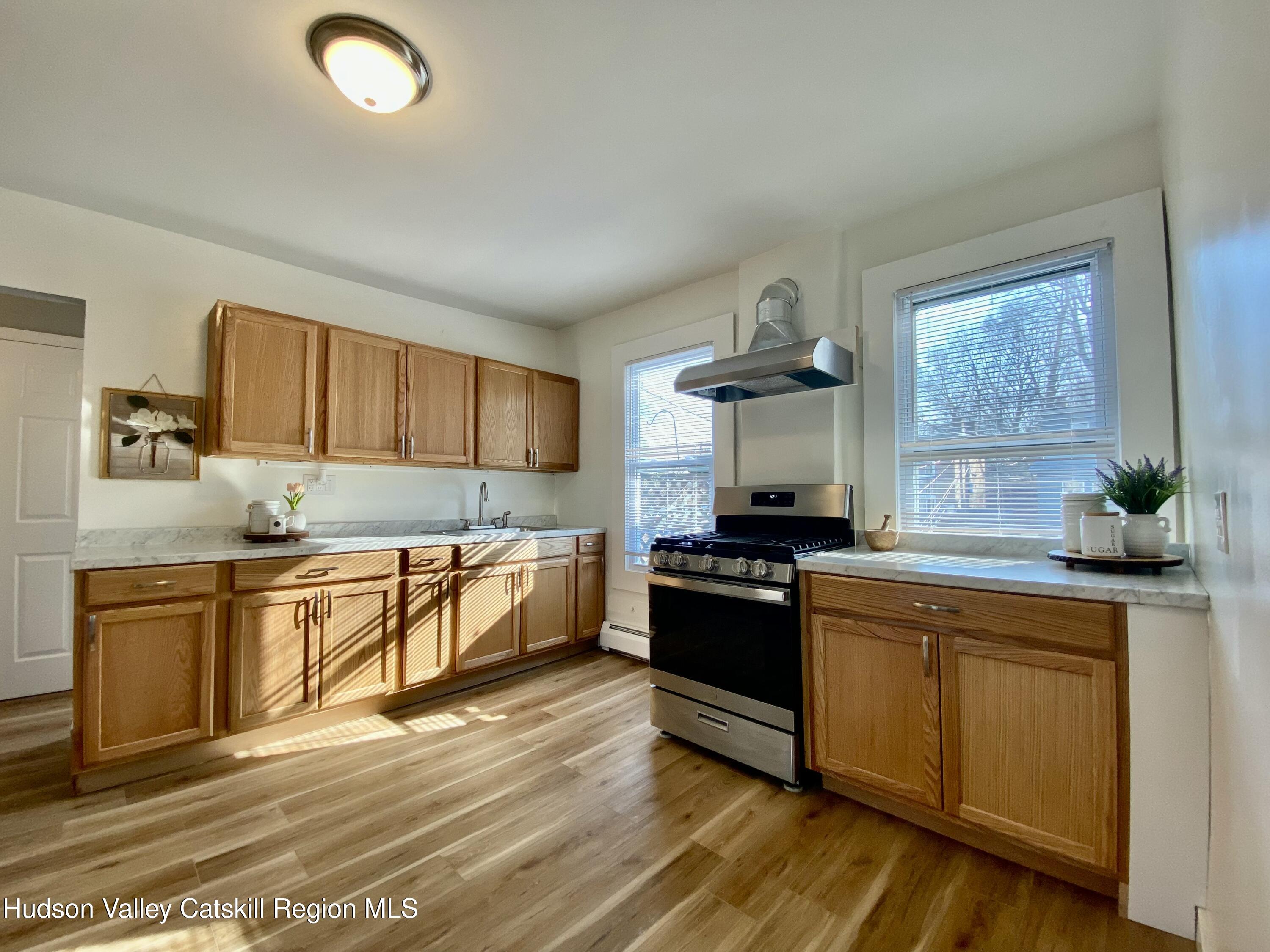 91 Broadway, Unit #2 Kingston, NY 12401 - Photo 2 of 14 a kitchen with stainless steel appliances granite countertop a stove a sink and a refrigerator