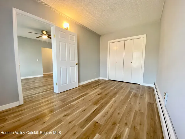 a view of a room with wooden floor