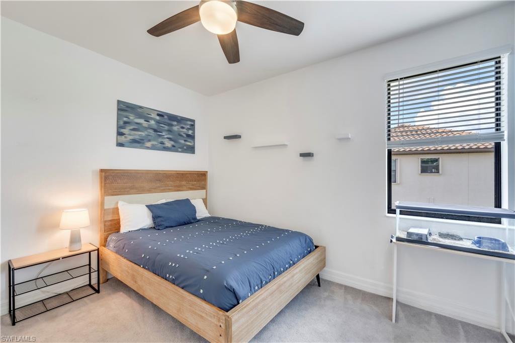 19128 Elston Way Estero, FL 33928 - Photo 34 of 50 a bedroom with a bed and a ceiling fan