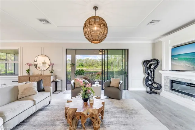 a living room with furniture a window and a flat screen tv