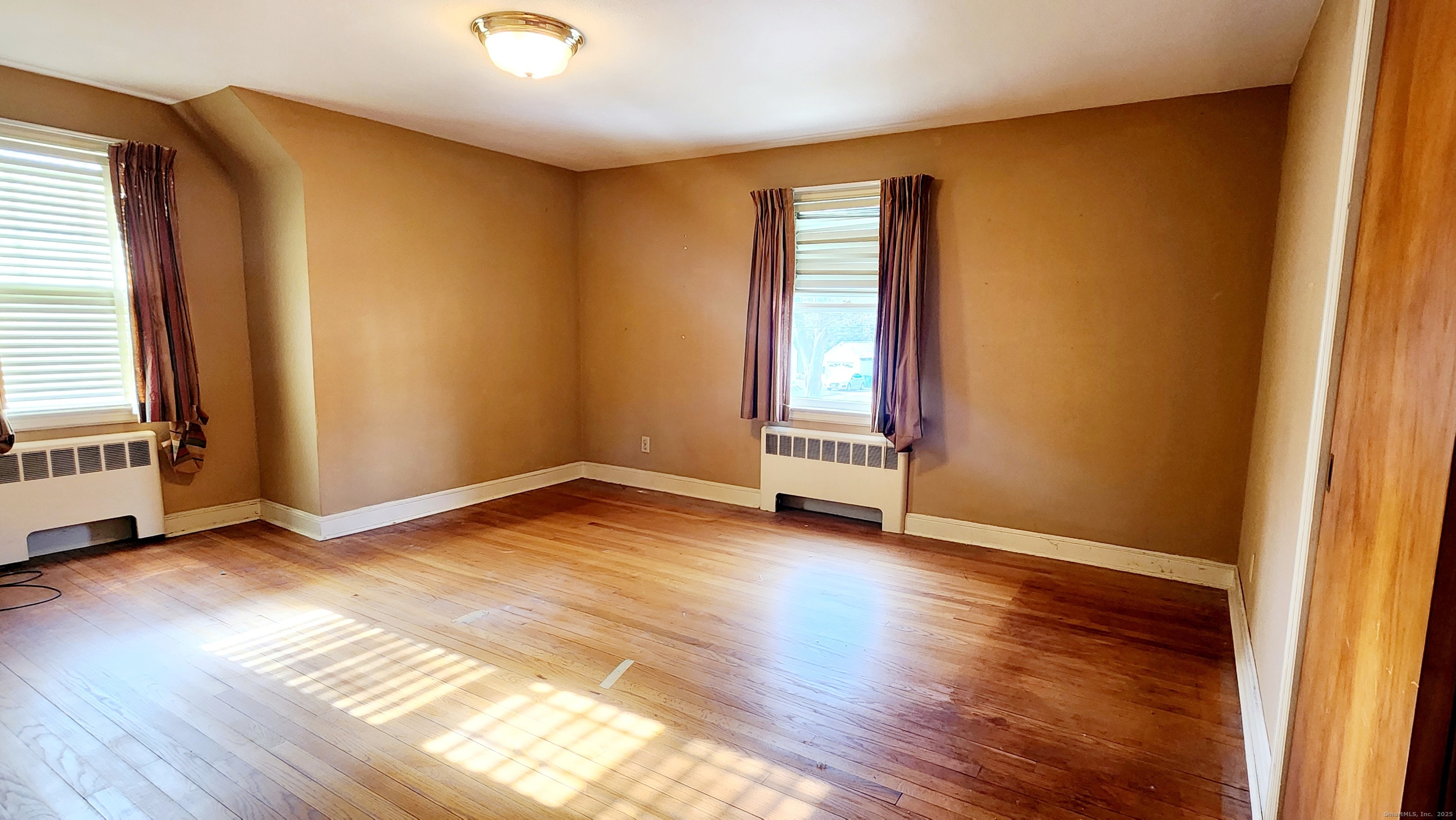 51 Tunxis Street New Britain, CT 06053 - Photo 11 of 18 an empty room with wooden floor and windows