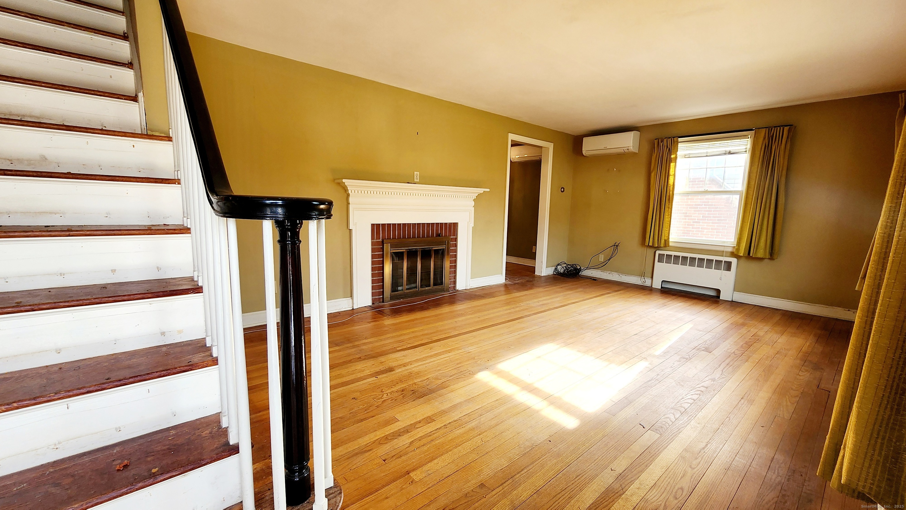 51 Tunxis Street New Britain, CT 06053 - Photo 2 of 18 a view of an empty room with wooden floor and a window