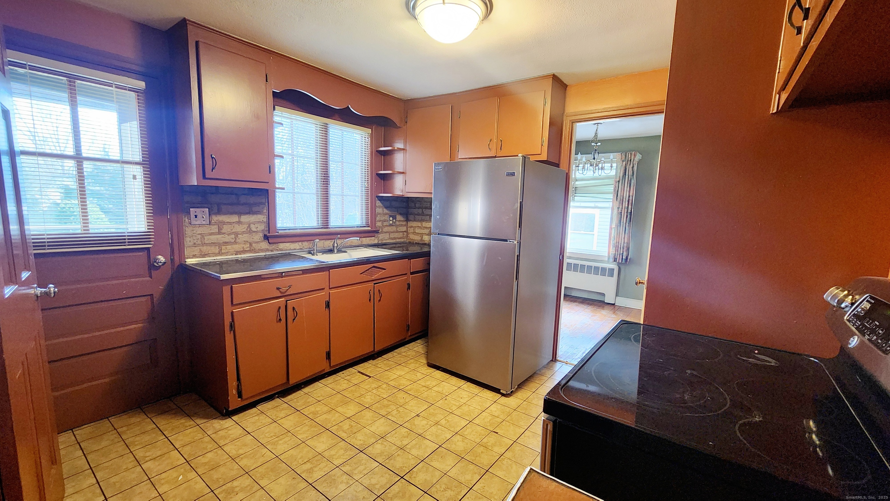 51 Tunxis Street New Britain, CT 06053 - Photo 4 of 18 a kitchen with a refrigerator sink and cabinets