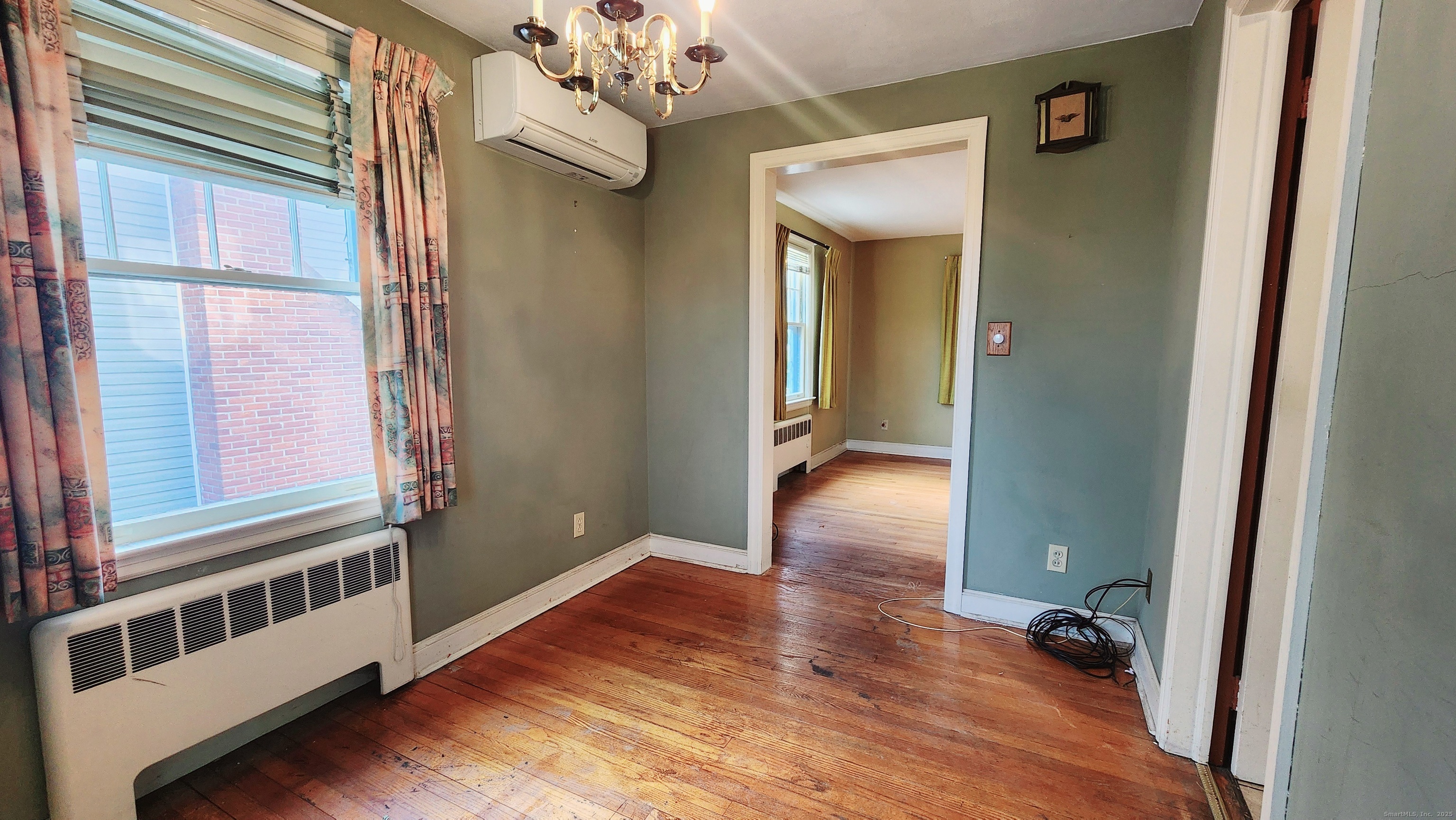 51 Tunxis Street New Britain, CT 06053 - Photo 5 of 18 a view of a hallway with wooden floor and staircase