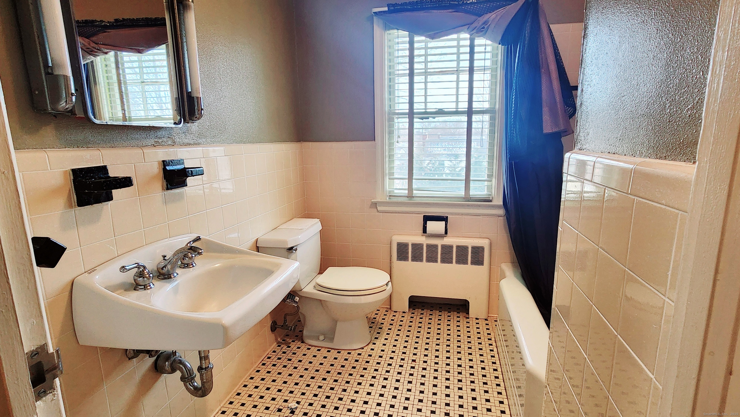 51 Tunxis Street New Britain, CT 06053 - Photo 9 of 18 a bathroom with a sink toilet a mirror and shower