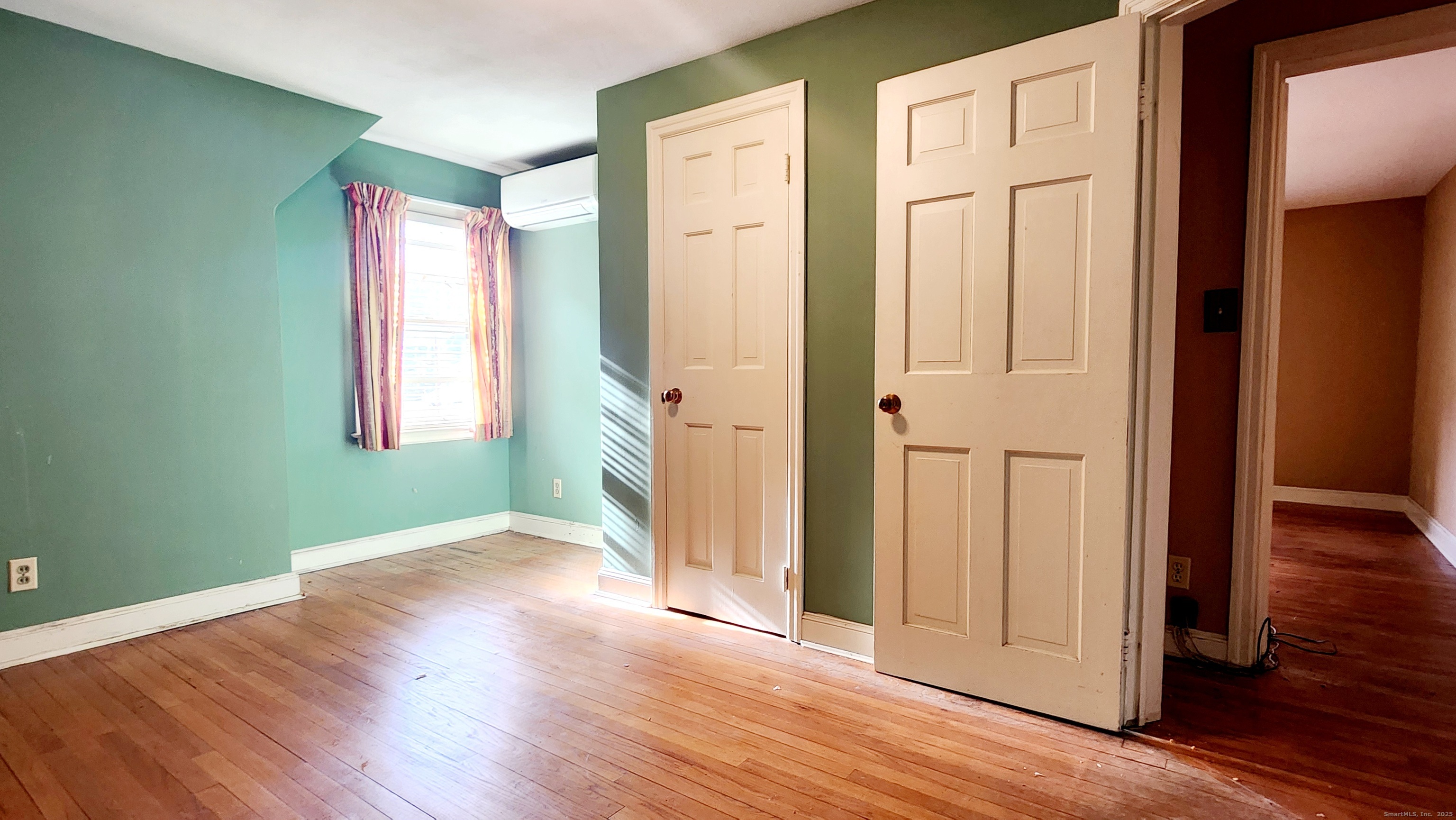 51 Tunxis Street New Britain, CT 06053 - Photo 10 of 18 an empty room with wooden floor and windows