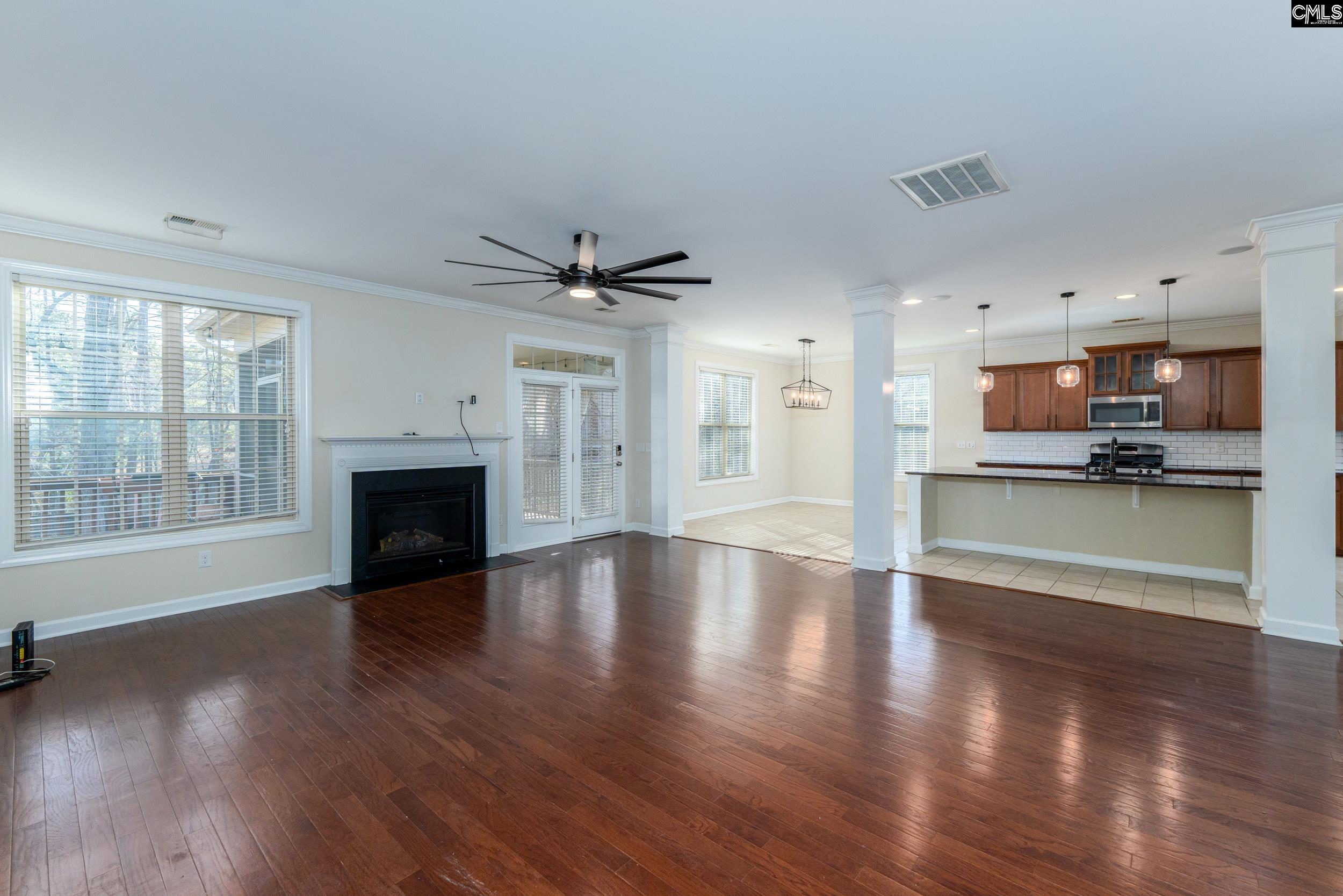 40 Wading Bird Loop Blythewood, SC 29016 - Photo 8 of 26 a view of a kitchen and an empty room with wooden floor and a kitchen
