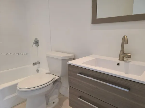 a bathroom with a sink a toilet and a bathtub