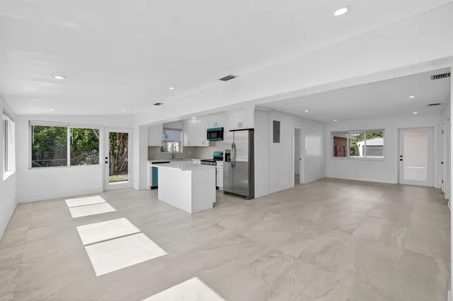 a kitchen with stainless steel appliances a stove microwave and refrigerator