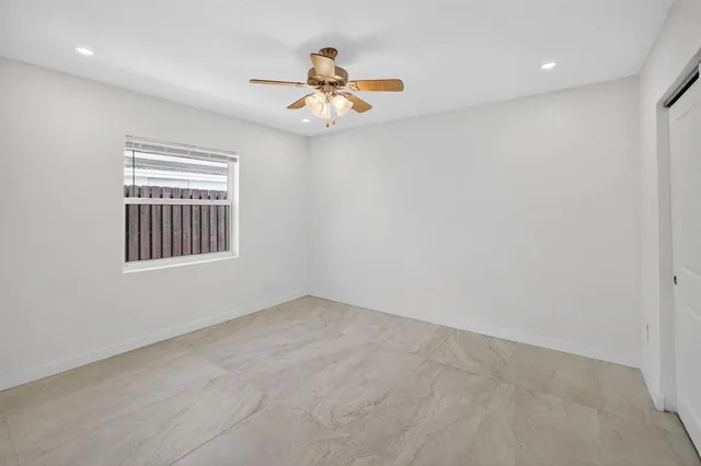 a view of a patio with table and chairs with wooden fence and plants