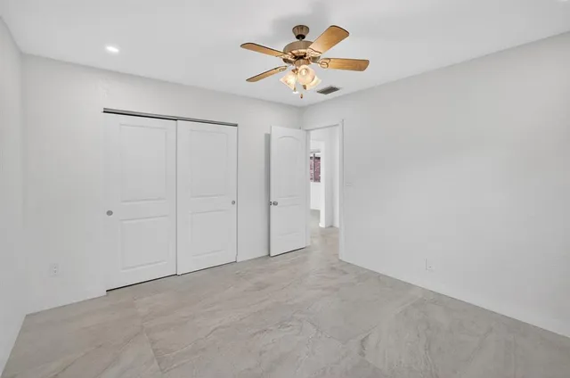 a view of a house with a swimming pool and sitting area