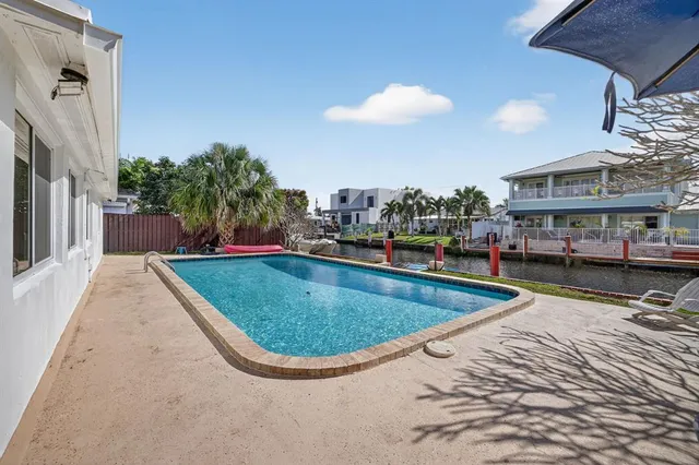 a yellow and red umbrella sitting in front of a house