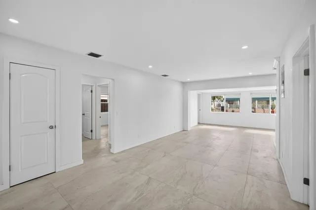 an empty room with a empty space and windows