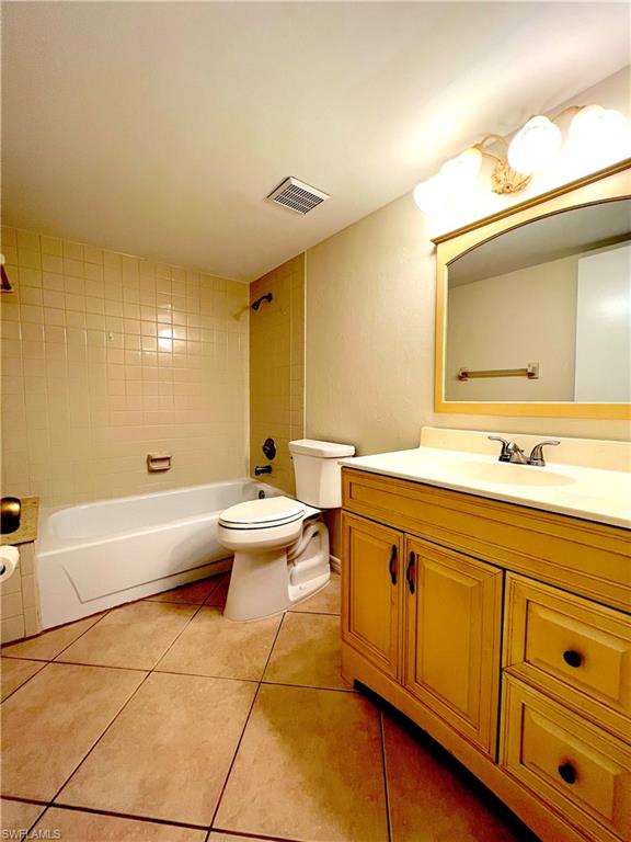 3471 County Barn Road, Unit F102 Naples, FL 34112 - Photo 15 of 19 a spacious bathroom with a double vanity sink a mirror and a